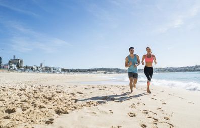 two people running along the beach on a weight loss holiday